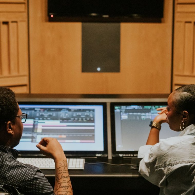 postgraduate-studies-at-sae two students sat at an audio desk