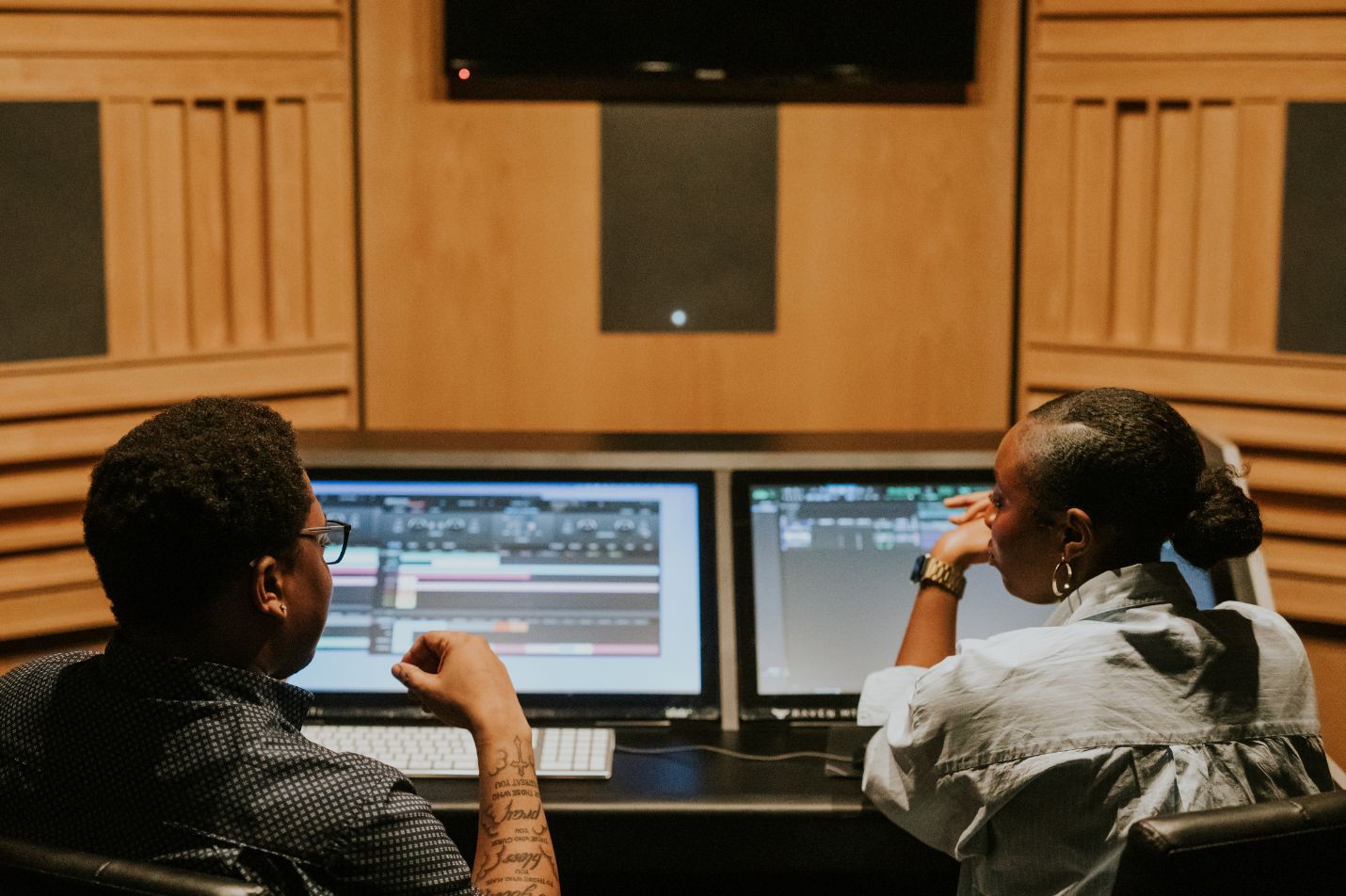 postgraduate-studies-at-sae two students sat at an audio desk